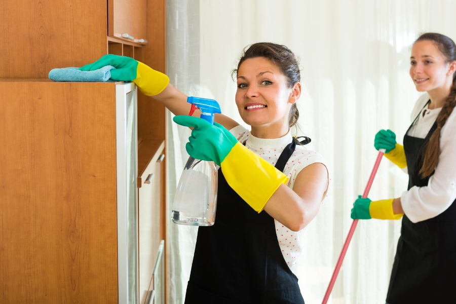 Female cleaners cleaning room