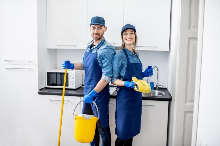 Man and woman as a professional cleaners indoors
